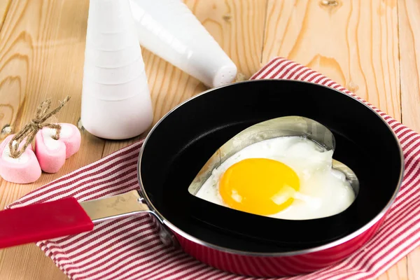 Fried egg in heart shape on pan — Stock Photo, Image