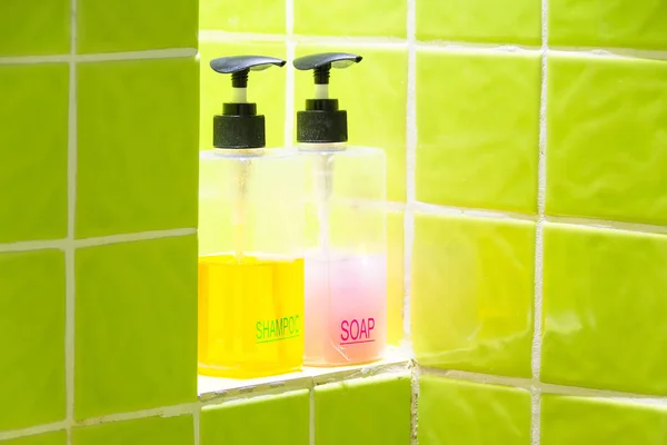 shower gel and shampoo on a shelf in bathroom