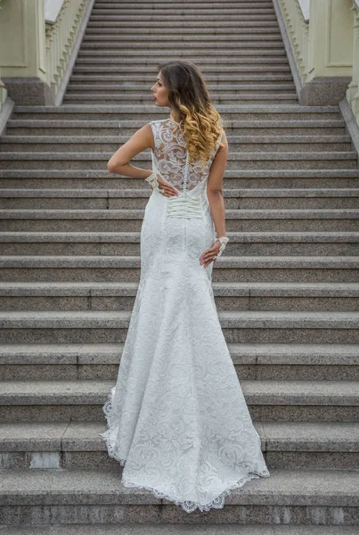 Beautiful bride in white wedding in outside of the manor house Stock Photo