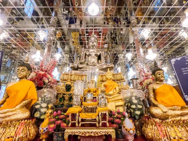 Gold buddha statue in Mosaic sanctuary (Glass Chapel) at Wat Muang, Angthong, Thailand. Beautiful of historic city at buddhism temple.