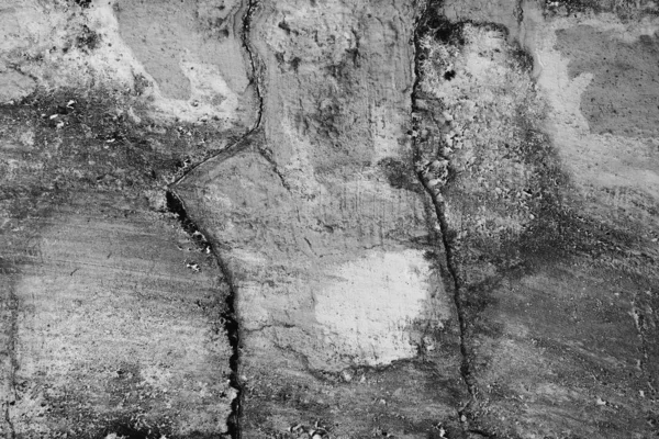 Close-up of White cement crack wall and peeled paint caused by water and sunlight. Peel wall of White house paint with black stain. Black and White of Texture background.