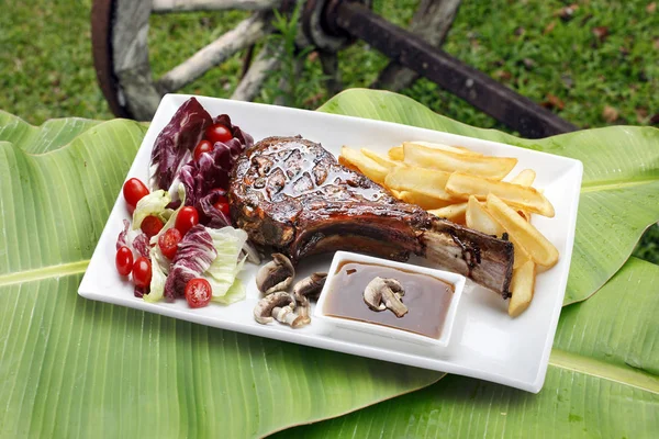 Prime rib with fries and salad — Stock Photo, Image