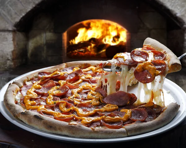 Slice of pizza raised — Stock Photo, Image