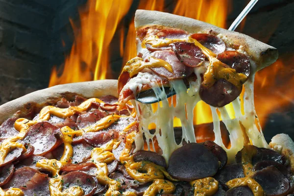 Slice of pizza raised — Stock Photo, Image