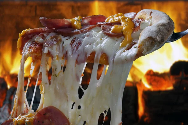 Hot pizza slice with melting cheese — Stock Photo, Image
