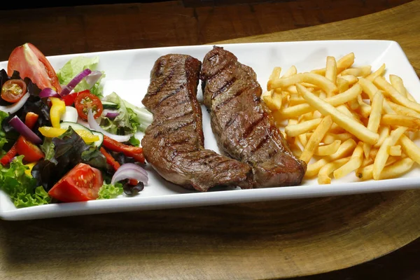 fillet steak with french fries and salad