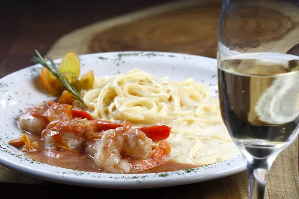 Appetizing pasta with shrimps and white sauce