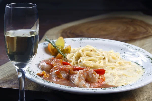 Appetizing pasta with shrimps and white sauce