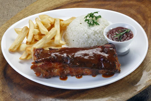 pork rib with barbecue sauce and garnishes