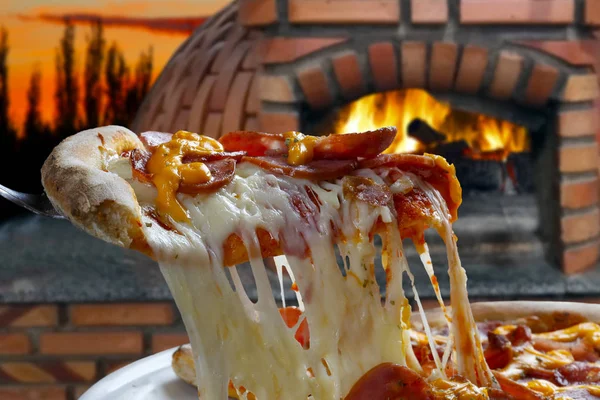 Hot pizza slice with melting cheese, close-up view