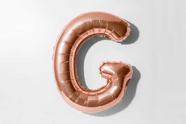 Letter G, Rose gold foil balloon alphabet isolated on a white background with Clipping Path