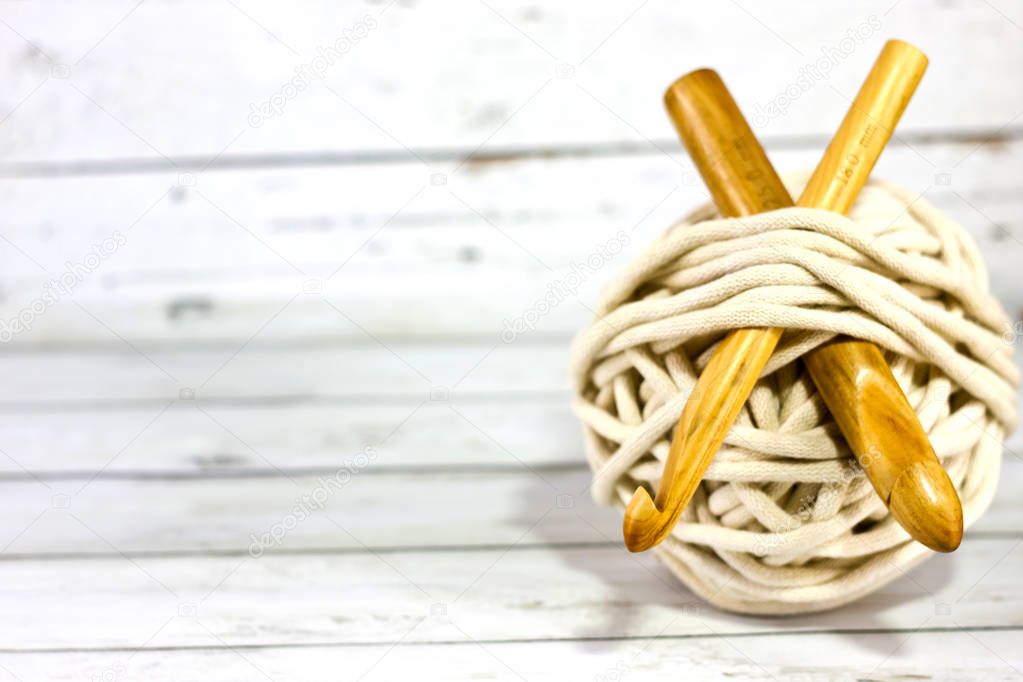 Yarns in basket with crochet hooks in harmonious colors. knitting, crocheting supplies.