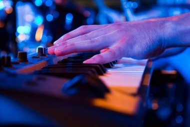 barda canlı gösterisi sırasında synthesizer oynarken elini