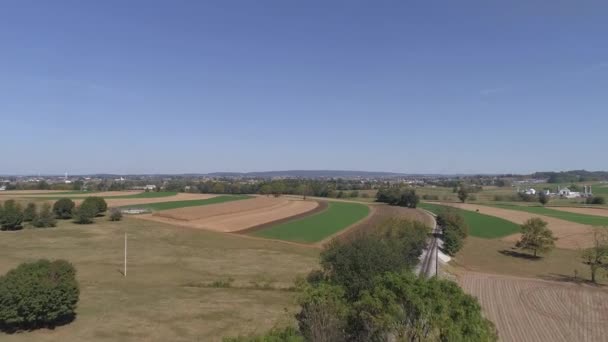 Aerial View Amish Countryside Farmer Working Field Rail Road Track — Stock videók