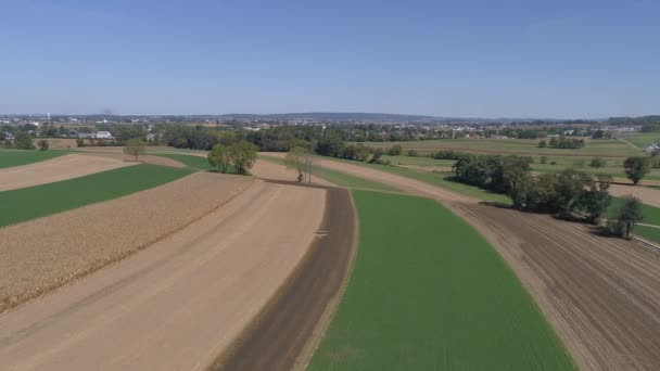 Aerial View Amish Countryside Farmer Working Field Rail Road Track — Stock Video