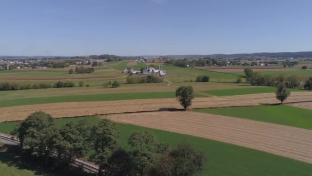 Aerial View Amish Countryside Farmer Working Field Rail Road Track — Stock videók