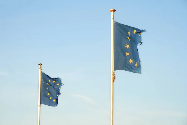 Tattered EU flags — Stock Photo, Image