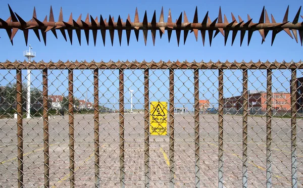 High voltage fence at industrial site — Stock Photo, Image
