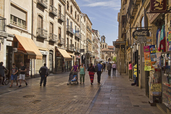 Salamanca, Spain - June 2, 2016: People walk in Calle Rua Mayor, the main shopping street in the old center of Salamanca, Spain on June 2, 2016