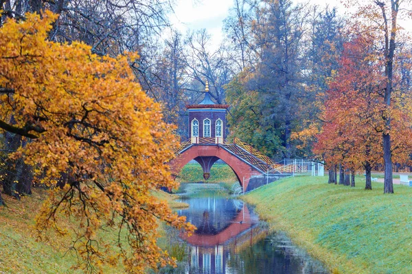Autumn landscape with a Cross bridge. — Stock Photo, Image