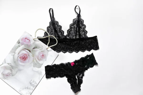 Sexy women lingerie. Beautiful black lace sexy lingerie on a white background. The concept of erotic linen, a date, a flat lay. Place for text. — Stock Photo, Image