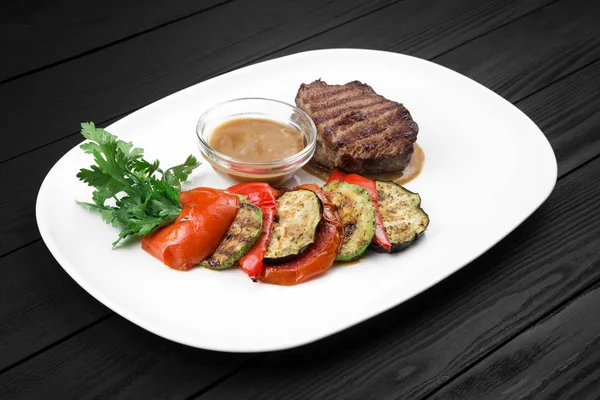 Grilled steak with vegetables on white plate. — Stock Photo, Image
