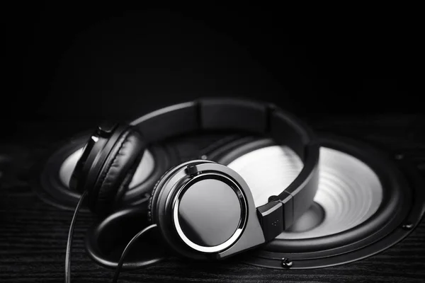 Photo de écouteurs noirs sur haut-parleur audio de musique. Gros plan . — Photo