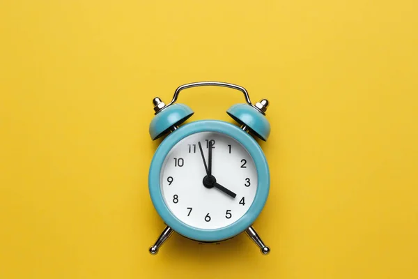 Blue round alarm clock on the cyan background. — Stock Photo, Image