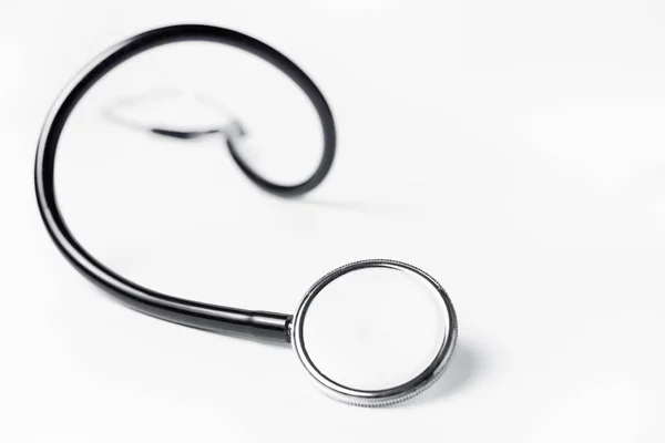 Photo of black medical stethoscope over white background.
