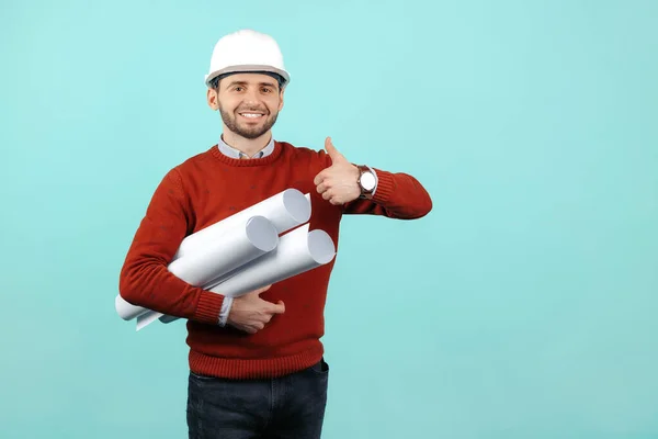 Gelukkig jong bebaarde ingenieur of constructeur man in casual outfit tonen slecht gebaar over cyaan achtergrond. — Stockfoto