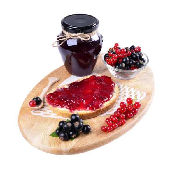 Black currant jam on a slice and in a jar — Stock Photo, Image