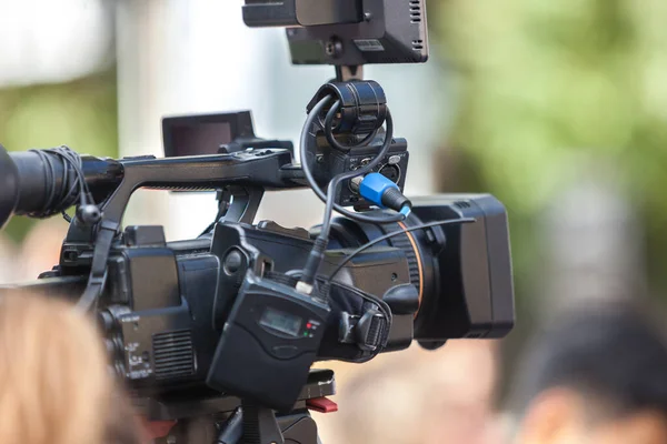 Man journalist with a modern large black video camera