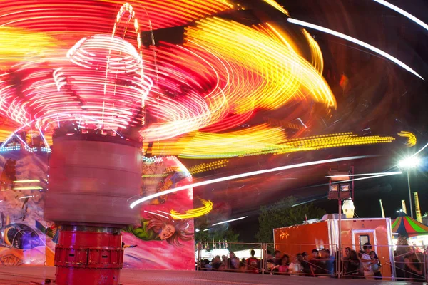 Motion Blur Of Streaking Lights From Fast Moving Carnival Ride — Stock Photo, Image