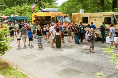People Stand In Line At Food Trucks During Atlanta Festival clipart