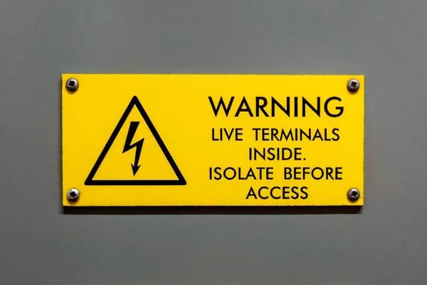 Live terminals inside isolate before access warning sign — 图库照片