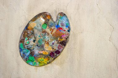 Duvarında renkli boyalar olan eski bir palet..