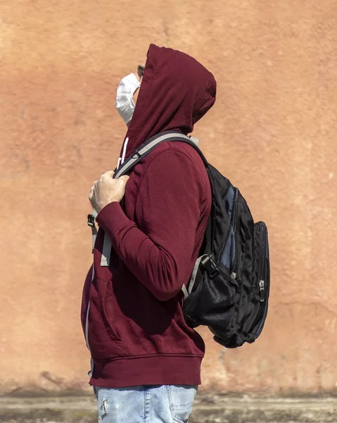 Backpacker Wearing Red Hoodie Medical Mask Yellow Wall Background Natural — Stock Photo, Image