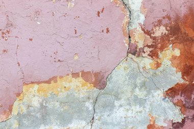 Pembe, pürüzlü duvar dokusu. Kırık alçı parçaları..