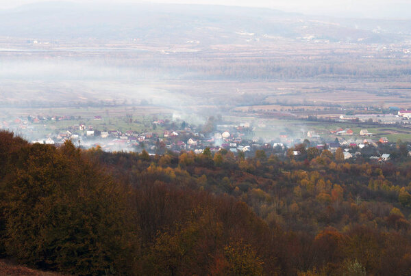 Panoramic view on fog village, Carpathian mountains, Ukraine. Horizontal outdoors shot