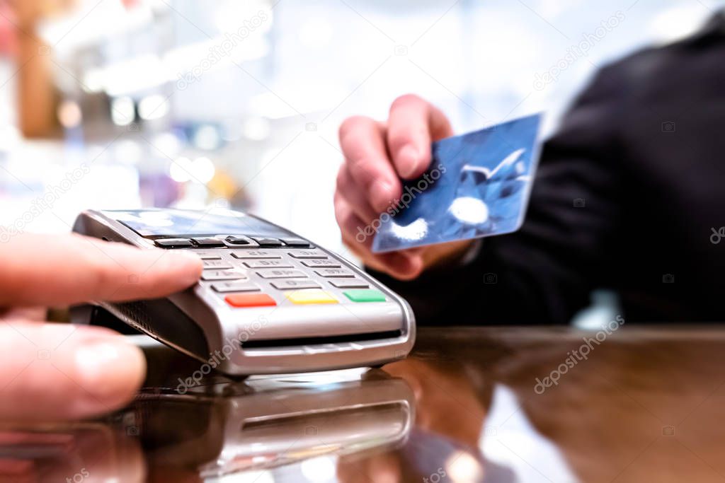 Payment by card, in the payment terminal. Electronic money. Mobile banking. Shopping complex.