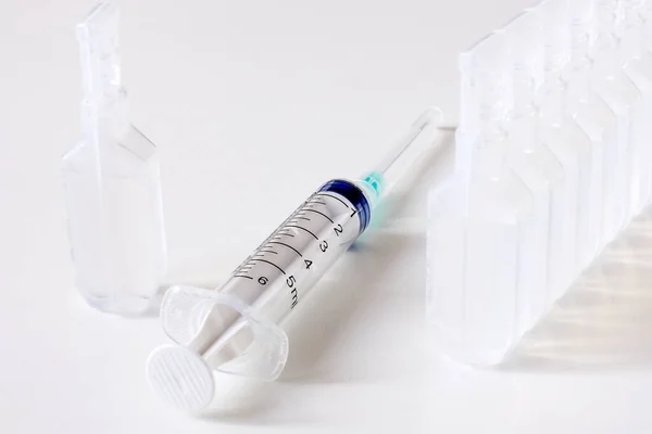 Syringes, water for injection, vials of vaccine. The concept of vaccination.