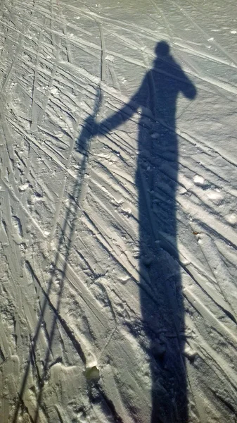 skier\'s shadow on white snow