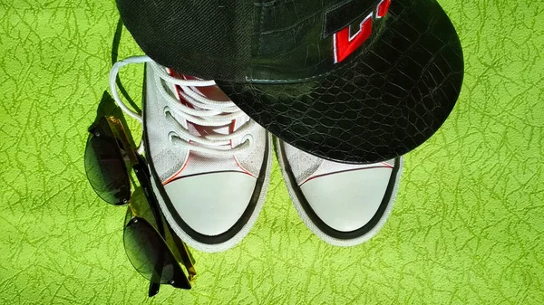 white sneakers. Sunglasses. Cap