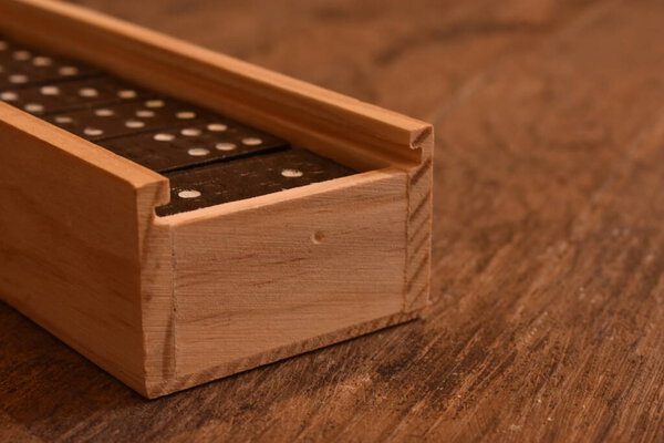 Game of dominoes in a wooden box