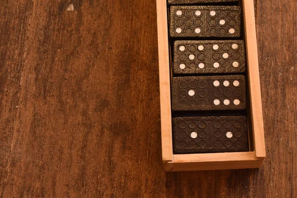 Game of dominoes in a wooden box