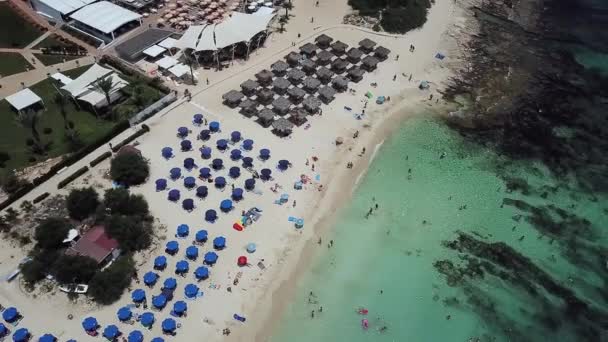 Drone vista da pitoresca bela praia de Nissi, em Chipre, com água azul-turquesa clara e um fundo rochoso — Vídeo de Stock