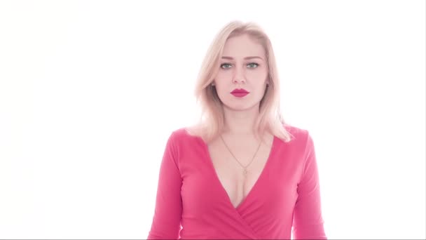 Sexy confident young woman in red dress with a deep neckline and red lips with her hands, straightens her chest in bra, touching boobs, looking at the camera, leaving the frame. Seduction, temptation — Stock Video