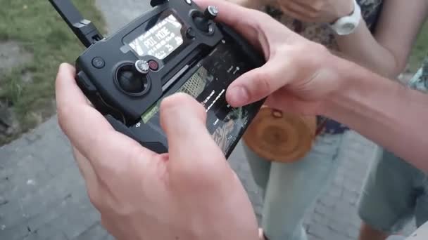 Nahaufnahme einer männlichen Hand, die eine ferngesteuerte Drohne mit einem Smartphone hält. Elektronik, Innovation, technologischer Fortschritt, Informationstechnologie — Stockvideo