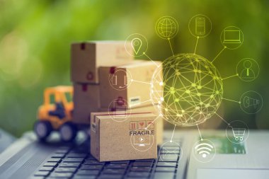 Lojistik, tedarik / Online alışveriş konsepti: Fork-lift, simge müşteri ağı bağlantısı olan karton kutuyu klavyede taşıyor. Çevrimiçi alışveriş için uluslararası taşımacılık hizmeti.