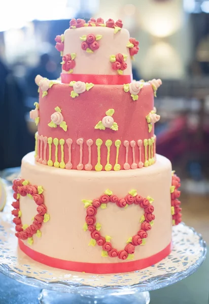 A bright pink cake for the holiday. Big pink wedding cake in three tiers